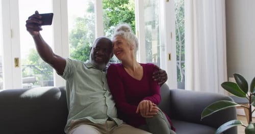 Smiling Senior Couple Taking Selfie at Home