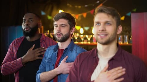 Three Young Men Singing Together Indoors