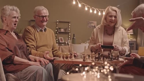 Seniors Enjoying a Chess Game Together Indoors