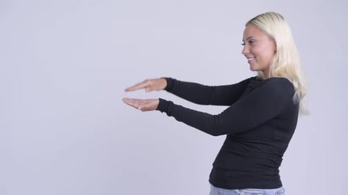 Smiling Woman Gesturing in Studio