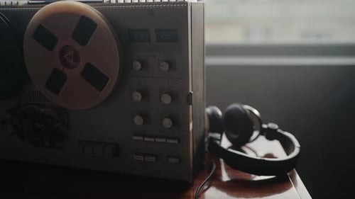 Vintage Reel-to-Reel Tape Recorder and Headphones