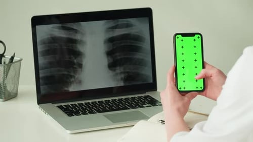 Hand Holding Phone with Green Screen and X-Ray