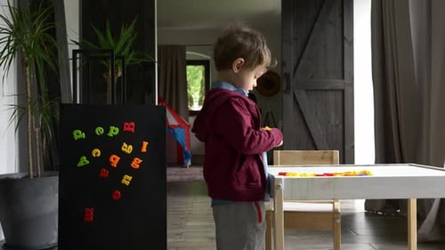 Child Playing with Magnetic Blocks Indoors