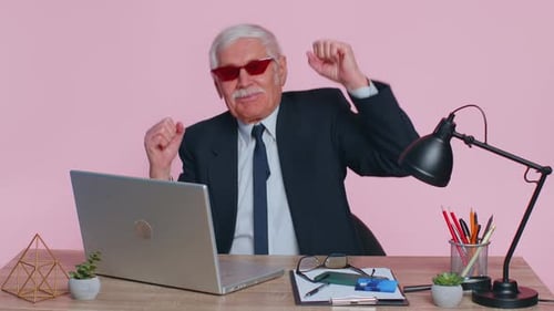 Glücklicher Senior Geschäftsmann tanzt Siegestanz feiert Wochenende Feiertag Erfolg Sieg im Büro