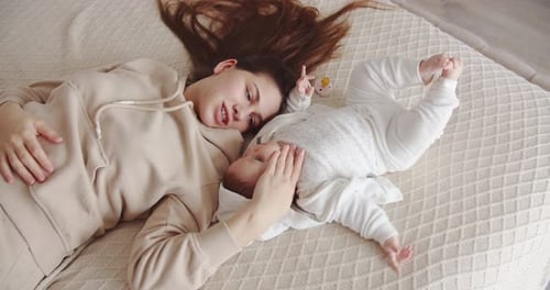 Mother and Baby Bonding on Bed