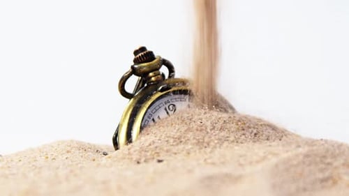 Alarm clock in sand