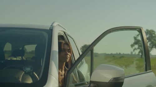 Woman Takes a Break on Country Road Trip