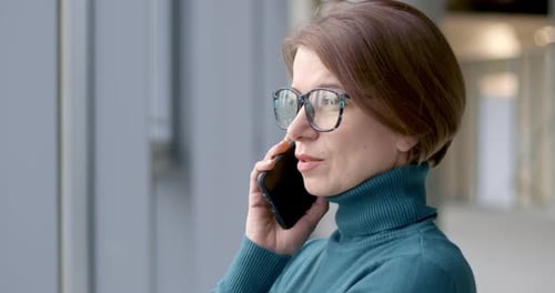 Woman Talking on Phone in Modern Urban Office