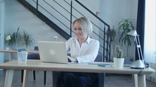 Happy Business Woman Finishing Work in Office