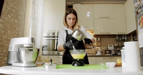 Woman Chef Pour Water From a Jug To Make Dough for a Cake or Cream. Close Up