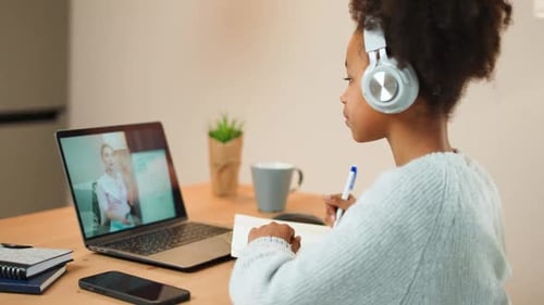 Child Attends Online Class on Laptop