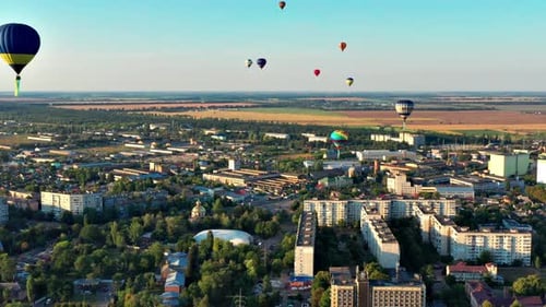 Scenic Aerial View of Town with Hot Air Balloons