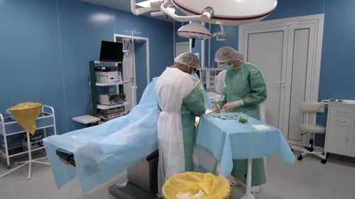 Doctors Doing Operation In Bright Room