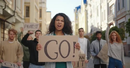 Public Demonstration at City Street with Mixed Race Woman in Front of Multiracial Protesting People