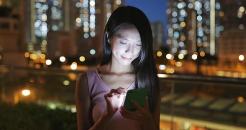 Woman use of mobile phone at night