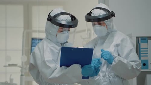 Close Up of Dentistry Doctors Talking Wearing Hazmat Suit