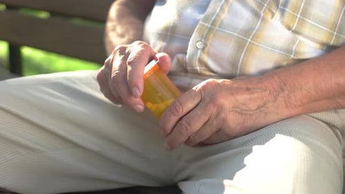 Senior Man Taking Pills From Bottle