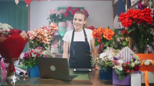 Florist Woman Using Tablet in Flower Shop
