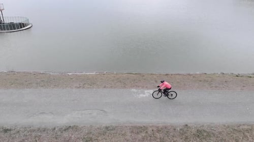 Professional road cyclist is pedalling alone outdoor. Isolated bike riding during quarantine.
