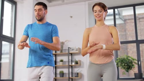 Happy Couple Exercising at Home