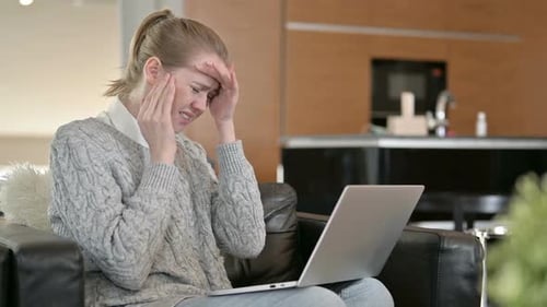 Woman Working on Laptop Experiencing a Headache