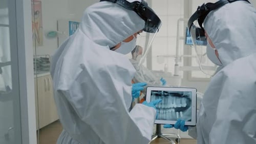 Dentists Analyzing Dental X-Ray in Hospital Setting