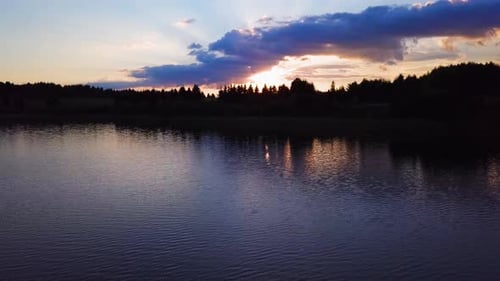 Amazing sunset on a lake. Beautiful colours. Shot from a drone flying low above the water. Relaxing