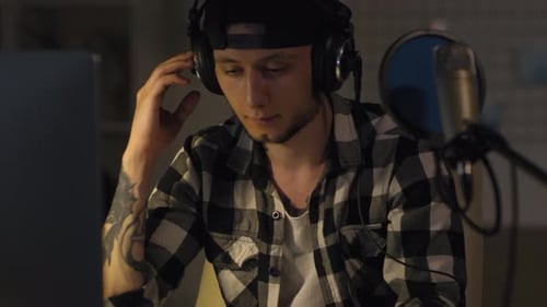 Male Musician Working in Home Recording Studio at Night
