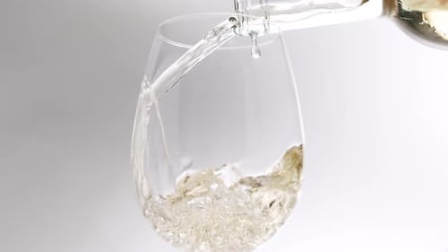 Pouring Refreshing White Wine in Wine Glass