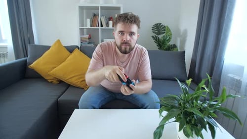 Man Playing Video Games at Home on Couch