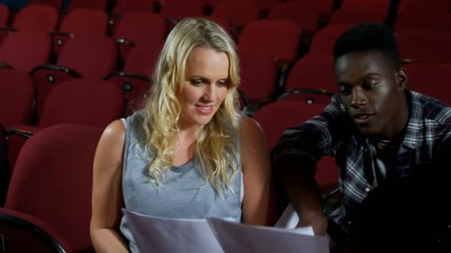 Actors Reviewing Scripts Together in Theater