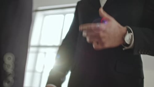 Two Business People Shaking Hands in Office