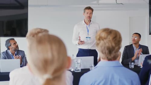 Speaker Presenting to Audience at Conference