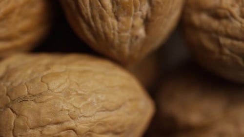 Extreme Close Up of Wrinkled Walnuts Piled Up
