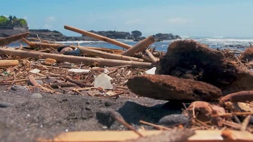 Plastic Bottles, Bags and Other Garbage Dumped on Dark Sand of Ocean Beach.