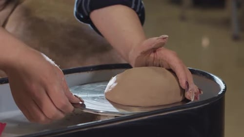 Pottery Crafting Throwing a Piece of Clay on the Wheel and Forming It to the Center