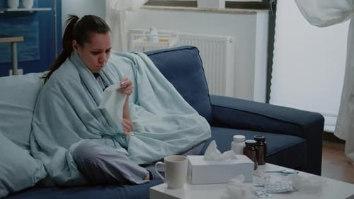 Woman With a Cold Covered in Blanket