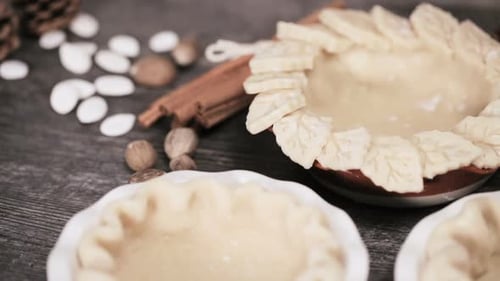 Preparing pie crusts for mini pumpkin pies.