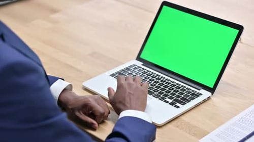 Adult Typing at Laptop with Green Screen