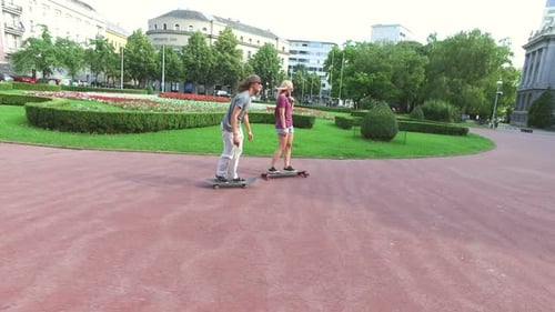 Young Adults Skateboarding in City Park
