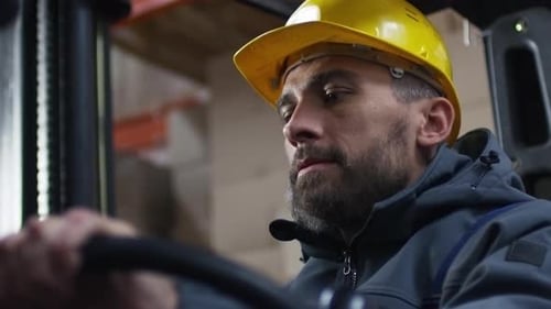 Warehouse Worker Operating Forklift