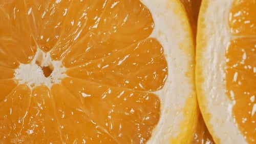Slow Motion of Rotation Ripe Sliced Oranges