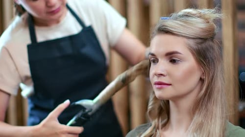 Woman Getting Hair Curled at Salon