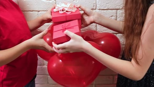 Offering Red Gifts with Heart Balloons