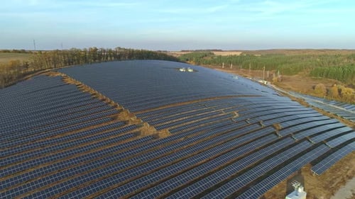 Aerial Drone Footage. Flight Over Solar Panel Farm at Sunset Autumn Season