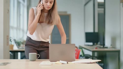Young Woman Talking on Phone at Modern Office