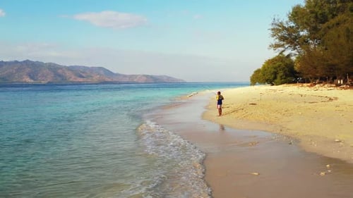 One man fishing alone on perfect lagoon beach voyage by turquoise ocean and white sand background of