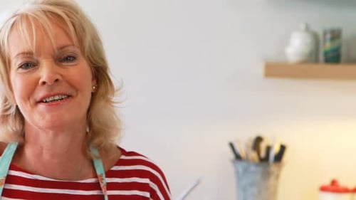 Blonde Woman Smiling in Kitchen Setting