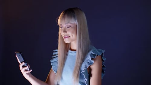 Young Adult Woman Using Smartphone at Night