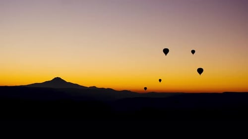 Hot Air Balloons Floating at Colorful Sunrise